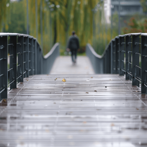 Person walking across a bridge representing a life transition